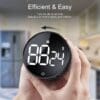 A person holding an electronic timer in their hand.