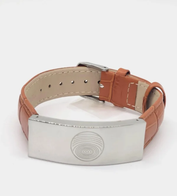 A brown leather bracelet with a metal plate on it.